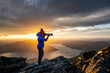 © Cavan Images - figure with camera above Queenstown and Lake, Remarkables New Zeala