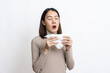© BJ Day Stock - Portrait of beautiful young asian sick woman over isolated white background being wrapped in scarf sneezing, suffering from runny nose and high temperature. Cold and fever concept.