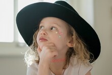 Portrait Of A Young Girl With Her Face Painted And Fancy Dress Hat