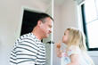 © Cavan Images - Side view of a toddler motioning for her dad to be quiet