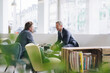 © Westend61 - Happy businessman in meeting with colleague at cafe