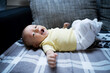 © Westend61 - Baby boy yawning on sofa at home