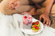 © Westend61 - Woman eating healthy breakfast on bed