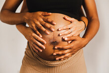 Hands Of Women Touching Pregnant Belly