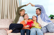 © Ilja - Happy family with kids sit on sofa in living room have fun using laptop together, smiling parents rest on couch enjoy weekend with childrens laugh watch video on computer at home