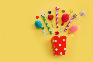 Top view image of party and present objects on yellow background