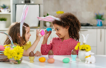 black and white children with rabbit ears on her head shows easter eggs