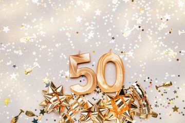 Wall Mural - Number 50 fifty golden celebration birthday candle on Festive Background. Fifty years birthday. concept of celebrating birthday, anniversary, important date, holiday