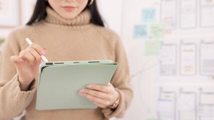 Poster - Woman, tablet and ui ux design with the developer being creative for mobile app project with a pen in office. Female planning, web design and development of wireframe on storyboard for website idea