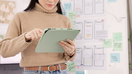 Poster - Woman, tablet and ui ux design with the developer being creative for mobile app project with a pen in office. Female planning, web design and development of wireframe on storyboard for website idea