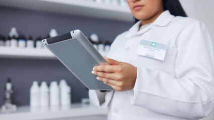 Poster - Young scientist using a digital tablet and microscope in a lab. Female pathologist analyzing medical samples while doing experiments to develop a cure. Microbiologist conducting forensic research