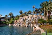 Waterfall And Pond With Palm Trees Next To The Mirage Hotel And Casino On The Strip In Las Vegas, Nevada.