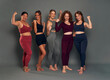 © gpointstudio - Group of happy five young women showing strength in sports clothes