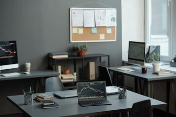 Fototapete - Part of openspace office with workplaces of economists or brokers analyzing stock market and illustrating its development by graphs