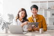 © M+Isolation+Photo - Asian couple husband and wife using laptop and paper bills at home use banking applications sit together at the table A cautious family spouse is confused by high expenses. insurance or rent concept