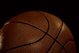 Fototapeta Sport - Basketball ball close up on dark background selective focus