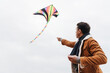 © Drobot Dean - Man playing with flying kite outdoors