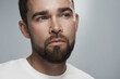 © blackday - Young and handsome bearded  man with clean skin against gray background