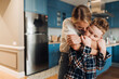 © Drobot Dean - Loving mother hugging her son while standing in kitchen