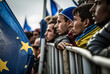 migrants stand at a fictitious border fence with the flag of Europe. Generative AI