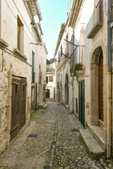 A narrow street between the old houses of Bovino, an ancient town in Puglia, Italy.