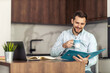© ivanko80 - Young freelancer is smiling, working in nice modern home