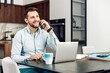 © ivanko80 - Young freelancer is smiling, typing on his laptop in nice modern home