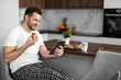 © ivanko80 - Man using tablet while having breakfast at home kitchen