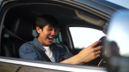 Wall Mural - Surprised young handsome man sitting in getting the new car. He hugged his a car as a gift from his savings and was feeling proud and very happy. Buy or rent car concept.