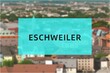 Eschweiler: Der Name der deutschen Stadt Eschweiler im Bundesland Nordrhein-Westfalen vor einem Hintergrundbild