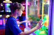 Kid Looking at the Toy Balls in an Arcade Claw Prize Machine Game
