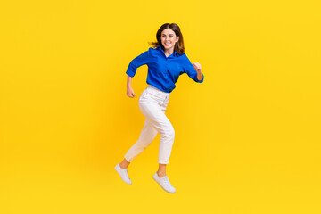 Sticker - Full length photo of excited charming girl dressed blue shirt hurrying jumping high isolated yellow color background