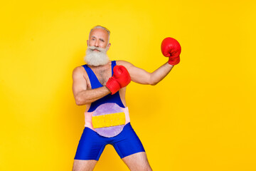 Poster - Photo of handsome charismatic grandfather arms boxing gloves fighting isolated on yellow color background