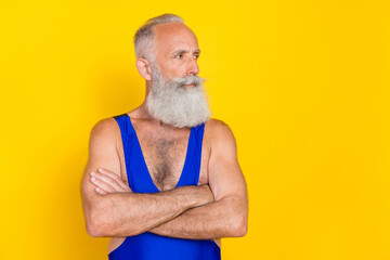 Poster - Photo of focused concentrated aged person folded hands look empty space isolated on yellow color background