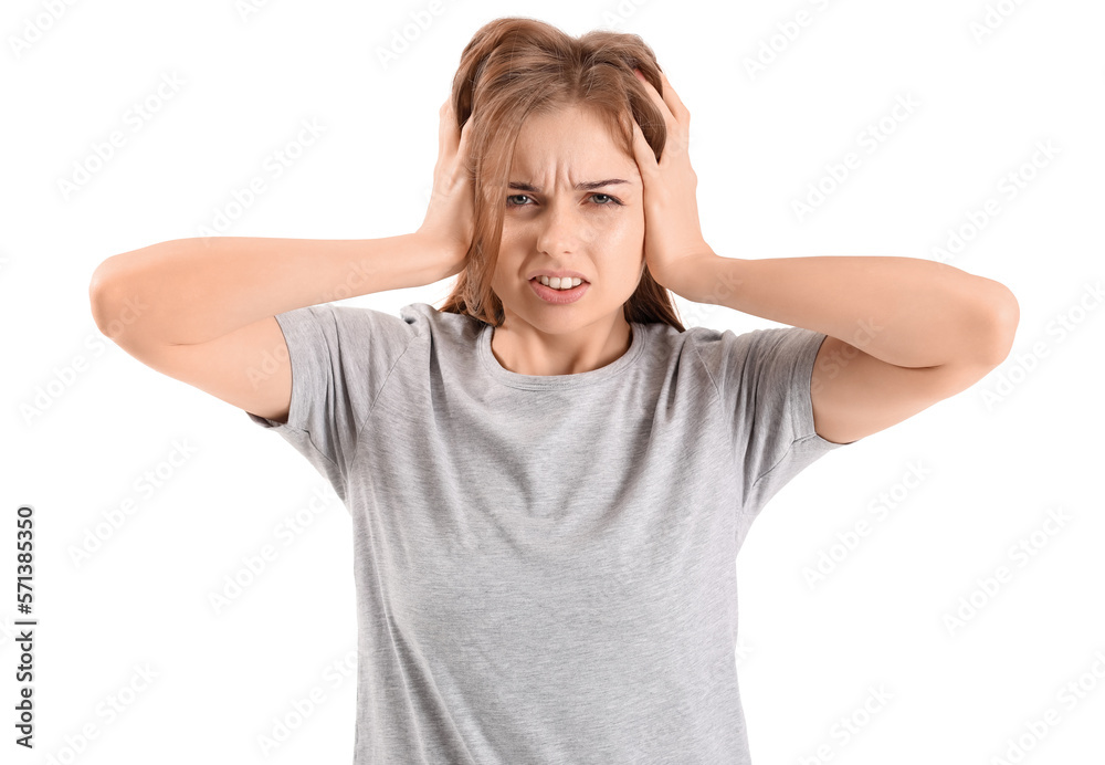 Irritated young woman suffering from loud noise on white background