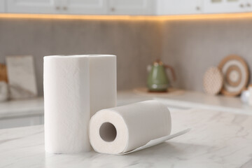 Wall Mural - Rolls of paper towels on white marble table in kitchen. Space for text