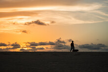 Silhouette Of A Person On The Beach At Sunset