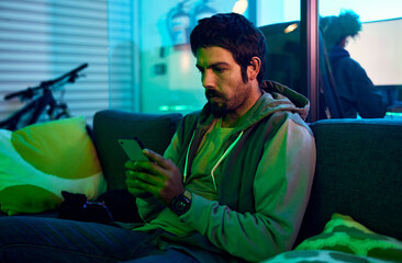 Leinwandbilder - Man, hacking or phone typing in neon garage on cybersecurity app, software programming or phishing coding. Hacker, technology or planning virus code on night sofa in ideas, vision or virus fraud scam