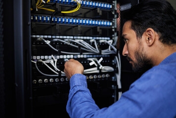 Engineer, server room and man with cable connection for software update or maintenance at night. Information technology wire, cloud computing and male programmer check database network in data center