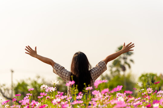happy woman raiseก open arms arms in flower garden, lifestyle and healthy confidence relax woman con