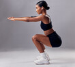 © T Mdlungu/peopleimages.com - Exercise, black woman and squat for training, workout and fitness for health, wellness and grey studio background. Female, lady and athlete bending, stretching and practice for endurance and energy