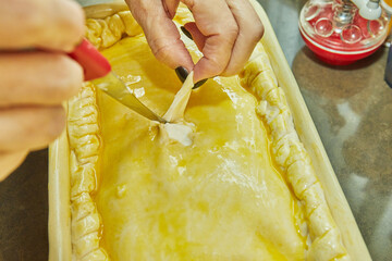 Canvas Print - Chef cuts holes in a souffle made from potatoes, courgettes, cauliflower and yellow cheese