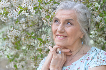 Sticker - beautiful old woman posing in park in spring