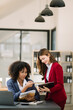 © Nuttapong punna - Two businesswoman discuss investment project working and planning strategy with tablet laptop computer in modern office..