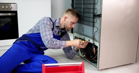 Wall Mural - Cropped Image Of Serviceman Working On Fridge With Screwdriver