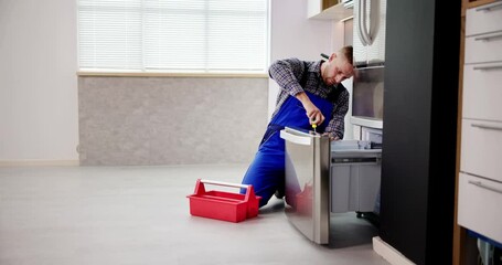 Wall Mural - Electrician Technician Working To Repair Refrigerator