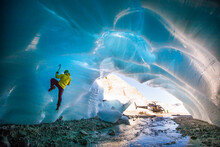 Man Ice Climbing In Ice Cave During Luxury Adventure Tour.