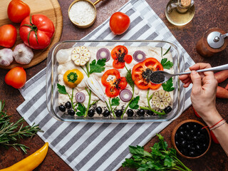 the girl sprinkles spices with homemade bread with vegetables. f