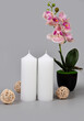 Two white candles on a gray background