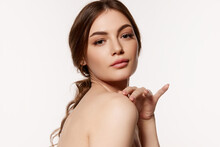 Portrait Of Young Beautiful Woman With Perfect Smooth Skin Isolated Over White Background. Nude Makeup. Concept Of Natural Beauty, Plastic Surgery, Cosmetology, Cosmetics, Skin Care.